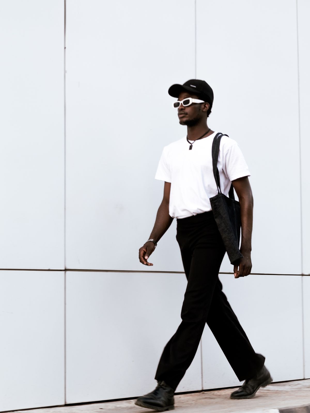 Black jeans paired with a white T-shirt and dark shoes.