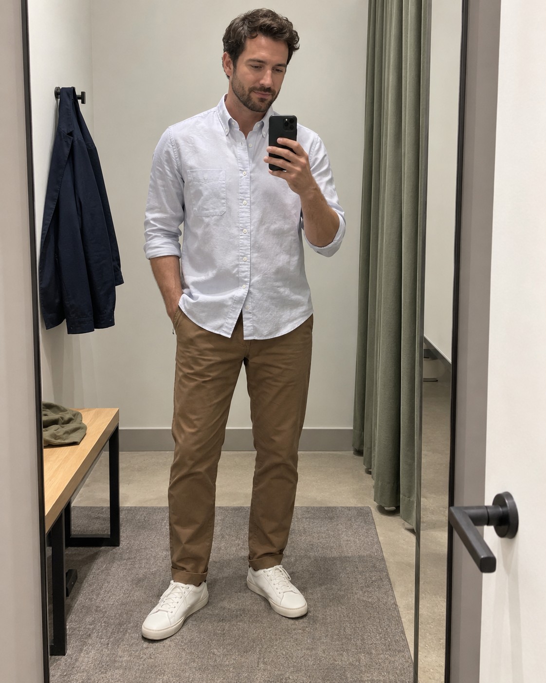 A full-length mirror outfit photograph showing shirt, chinos and trainers.