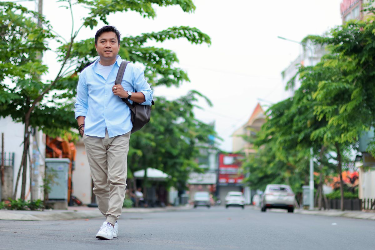 A light-blue shirt and pale trousers worn outdoors.