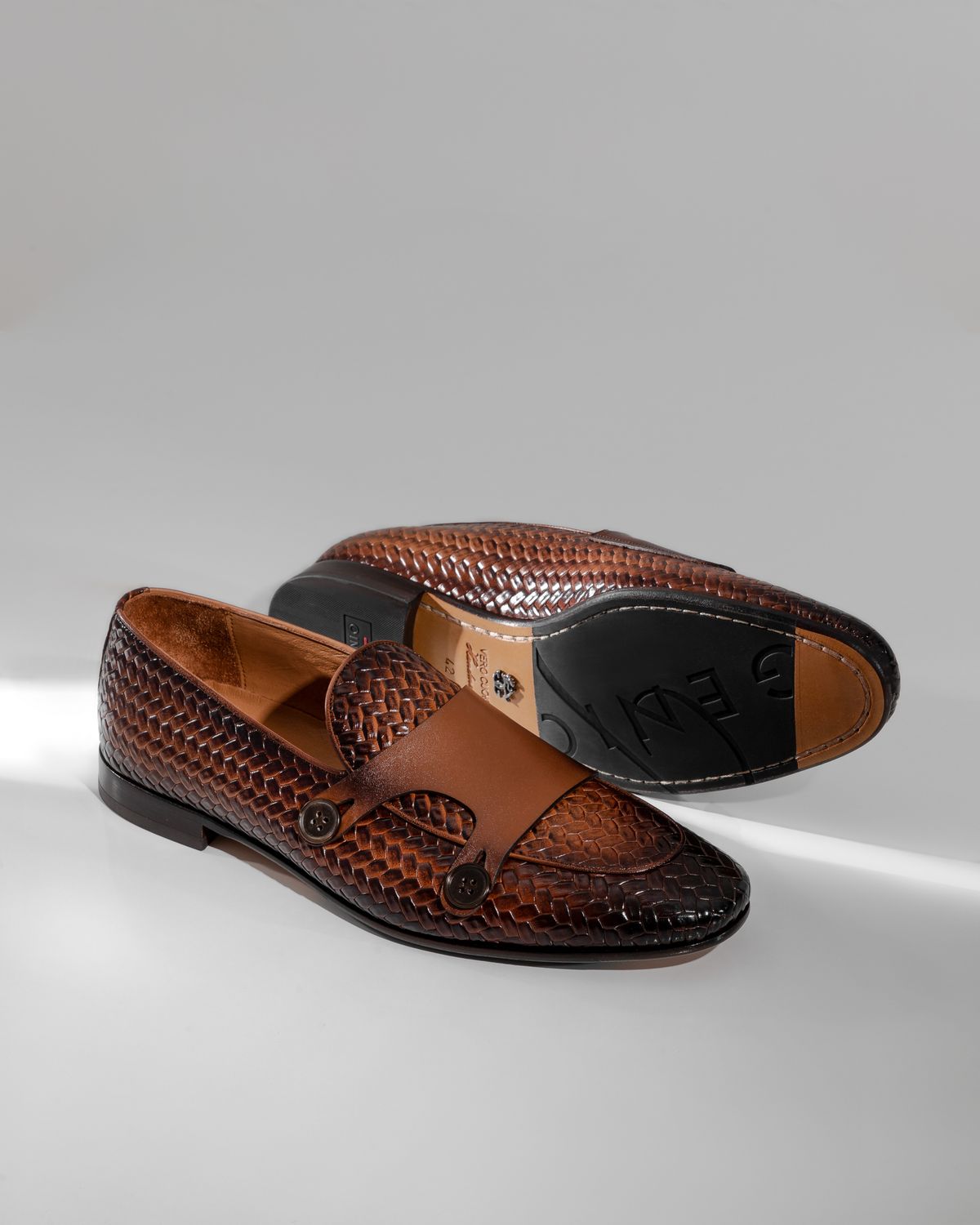 A pair of brown leather slip-on loafers.