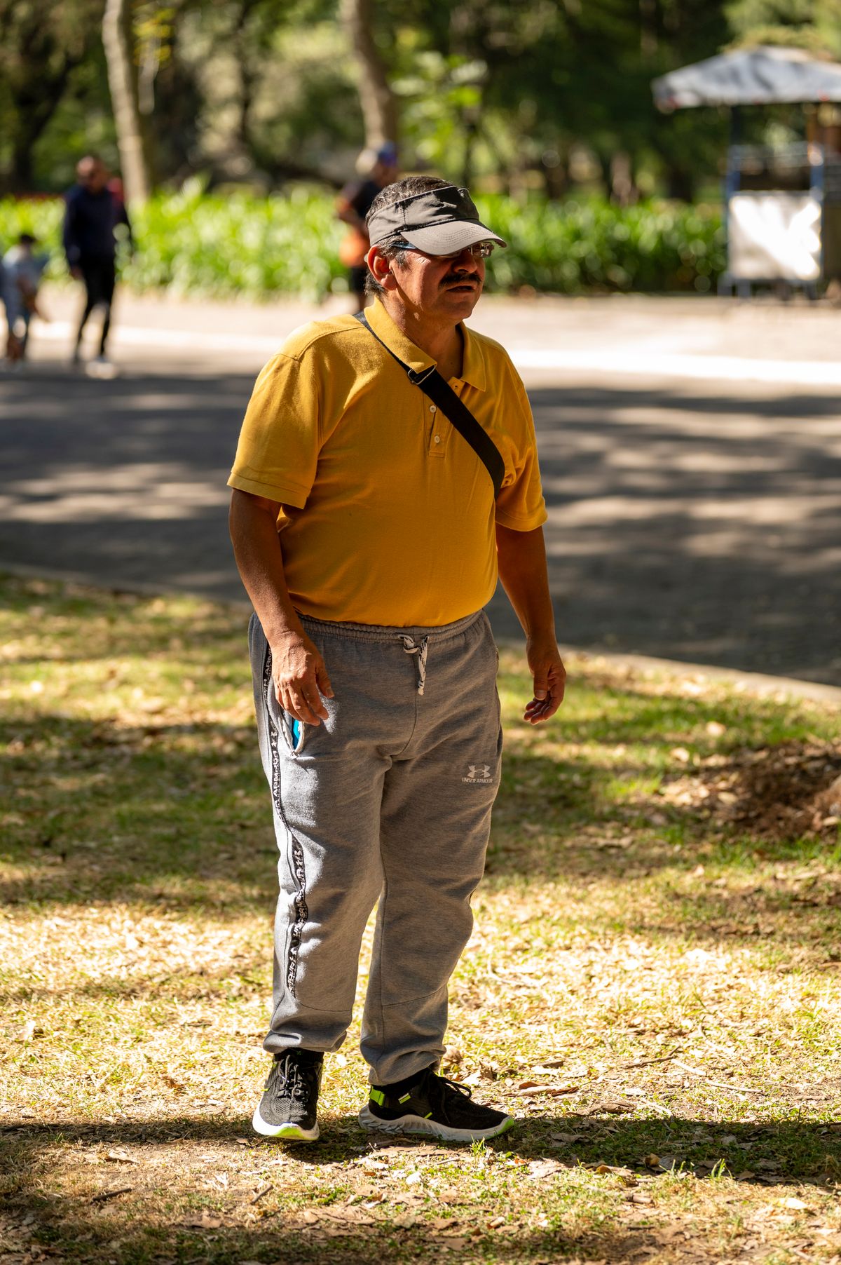 A yellow polo shirt worn with neutral trousers on a park walk.