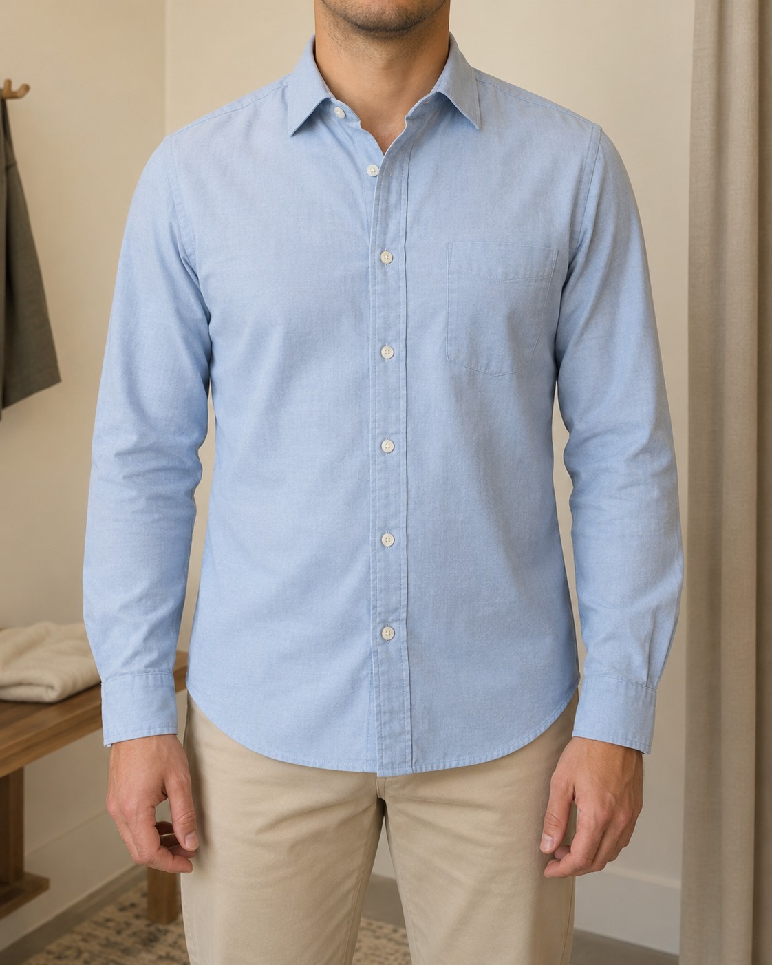 A light-blue casual shirt showing shoulder seams, sleeves, straight placket and curved hem.